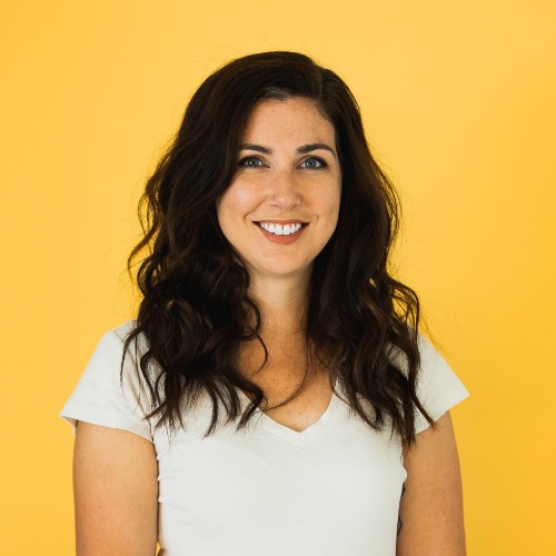 a headshot of Esther against a yellow background